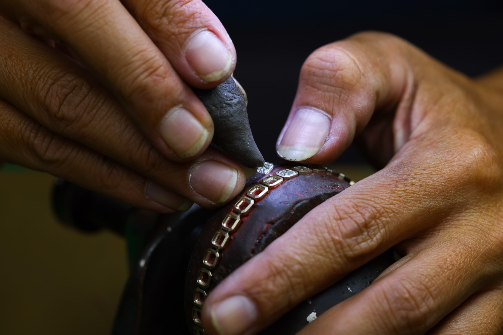 Stones hand-set into a channel band held in setting wax